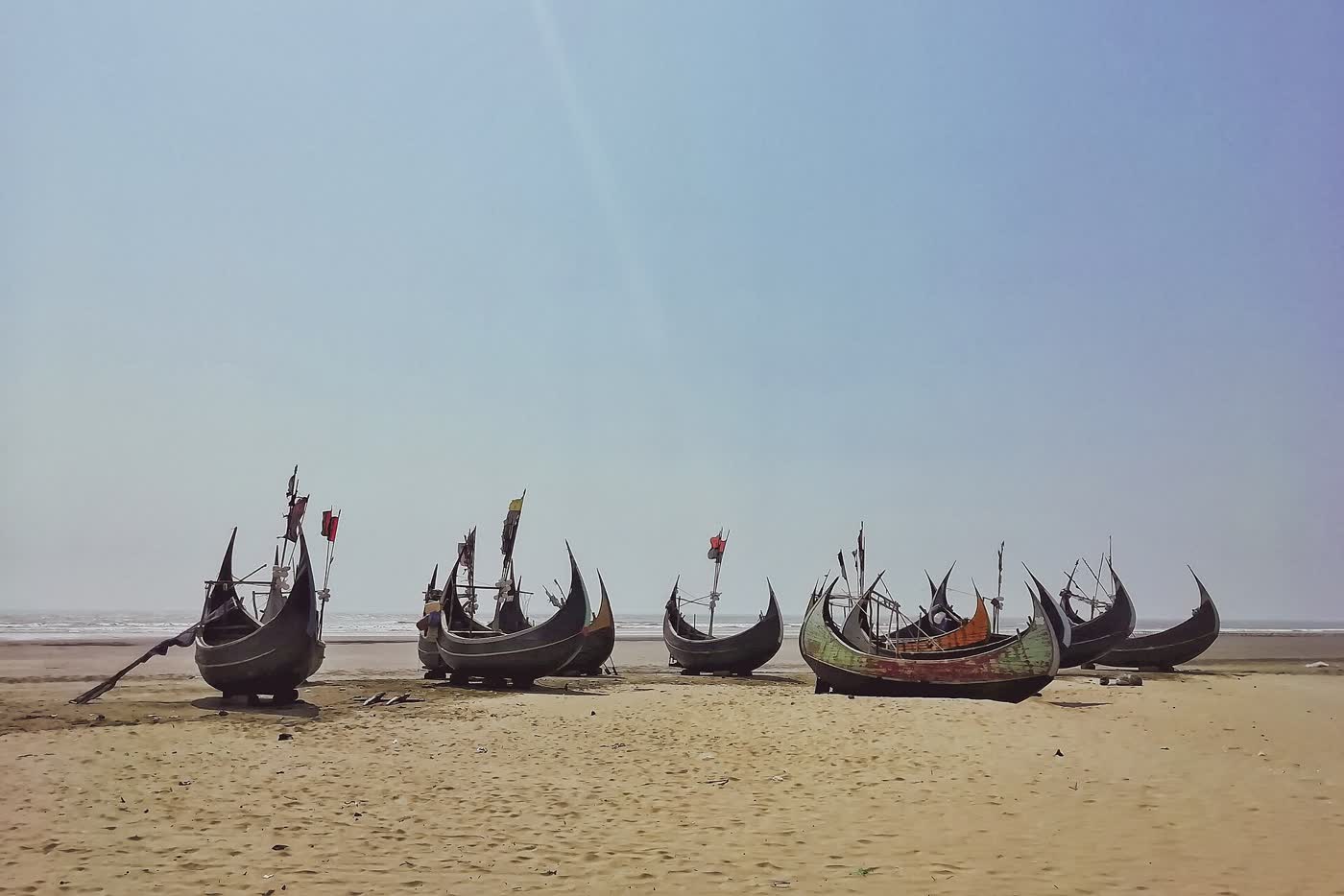 Moon-prowed fishing boats drawn up on the beach