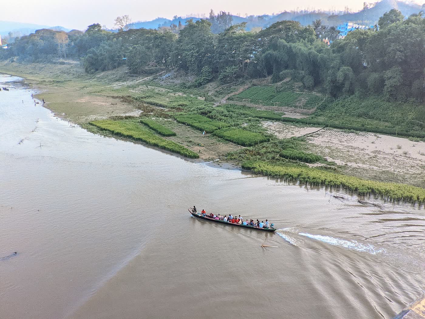 The Sangu curving between hills with a single boat